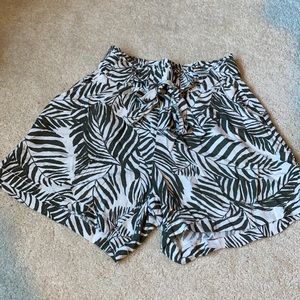 White shorts with tropical leaf prints.